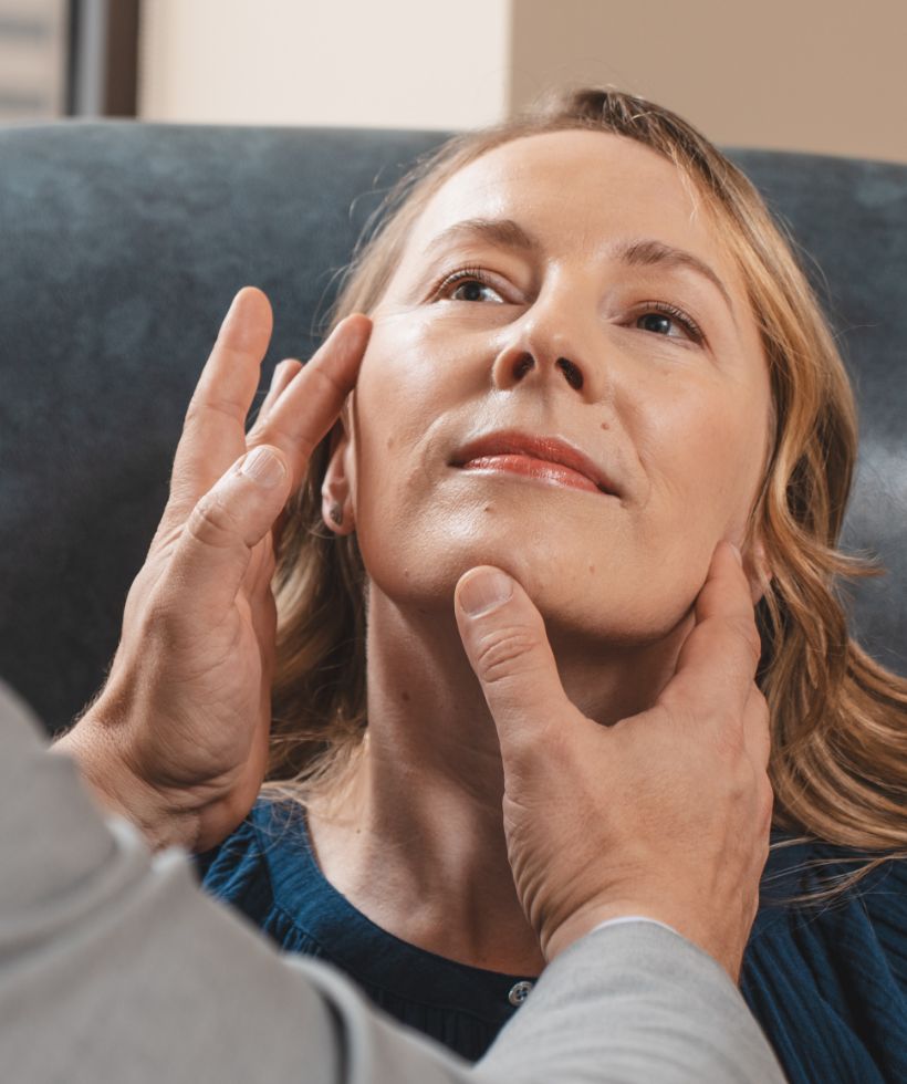 Dr. Gougoutas evaluating a Patient's face